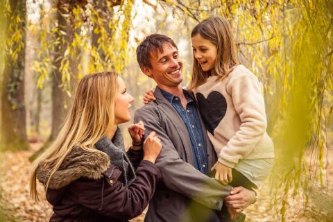 Lifestyle: Beautiful family enjoying their time walking in the park on a summer autumn day.